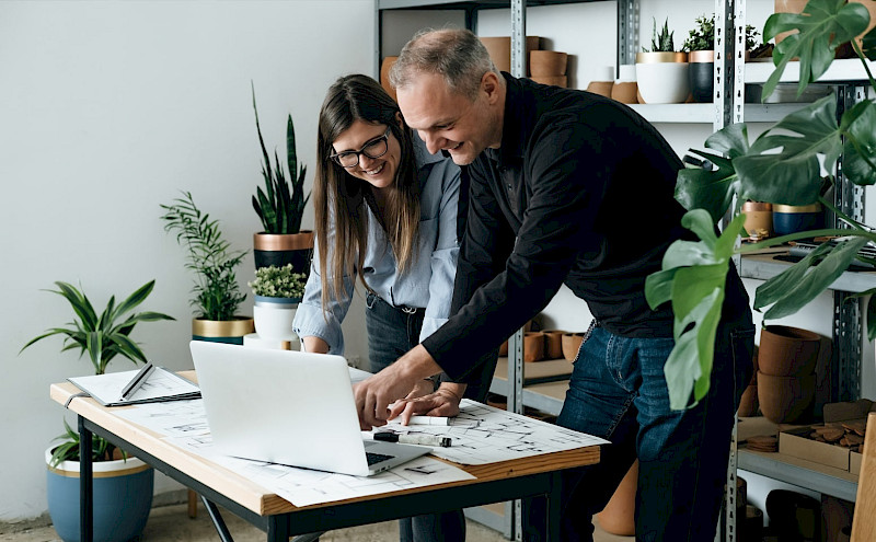 Zwei Mitarbeiter schauen sich auf einem laptop den Advertorial Ihres Unternehemns bei Focus.de an